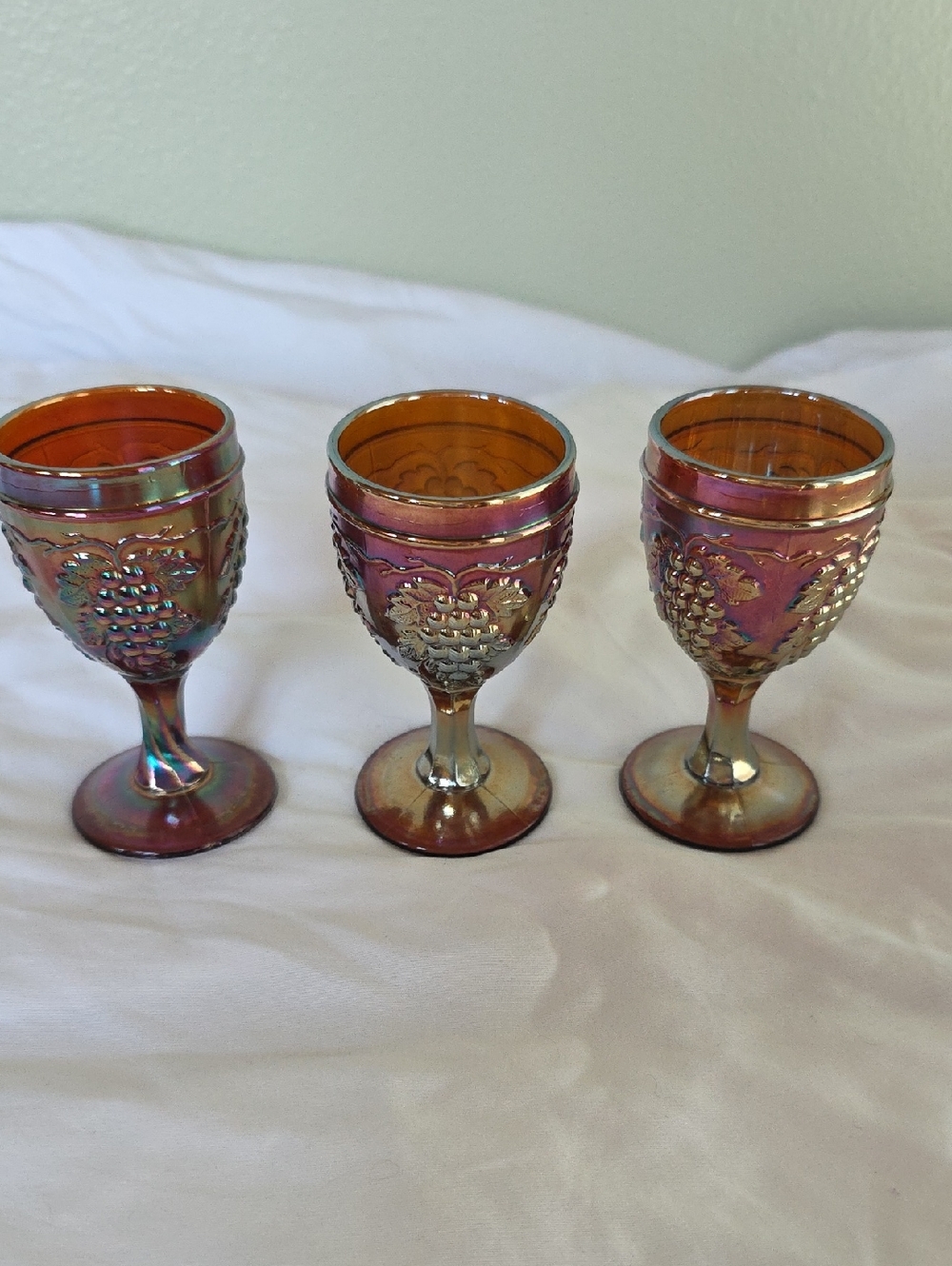 Set of three Imperial Grape carnival glass cordial glasses.
